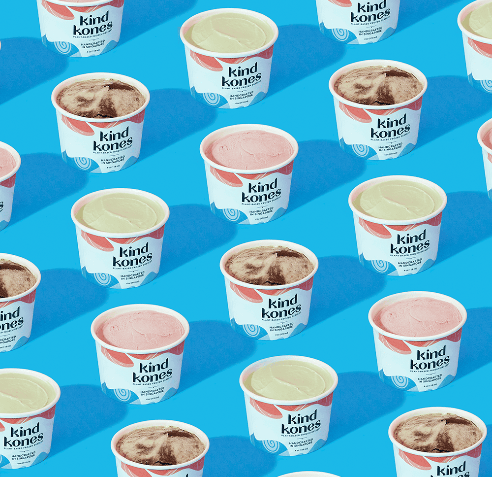 Kind Kones ice cream cups showcasing branding and packaging design on a blue background.