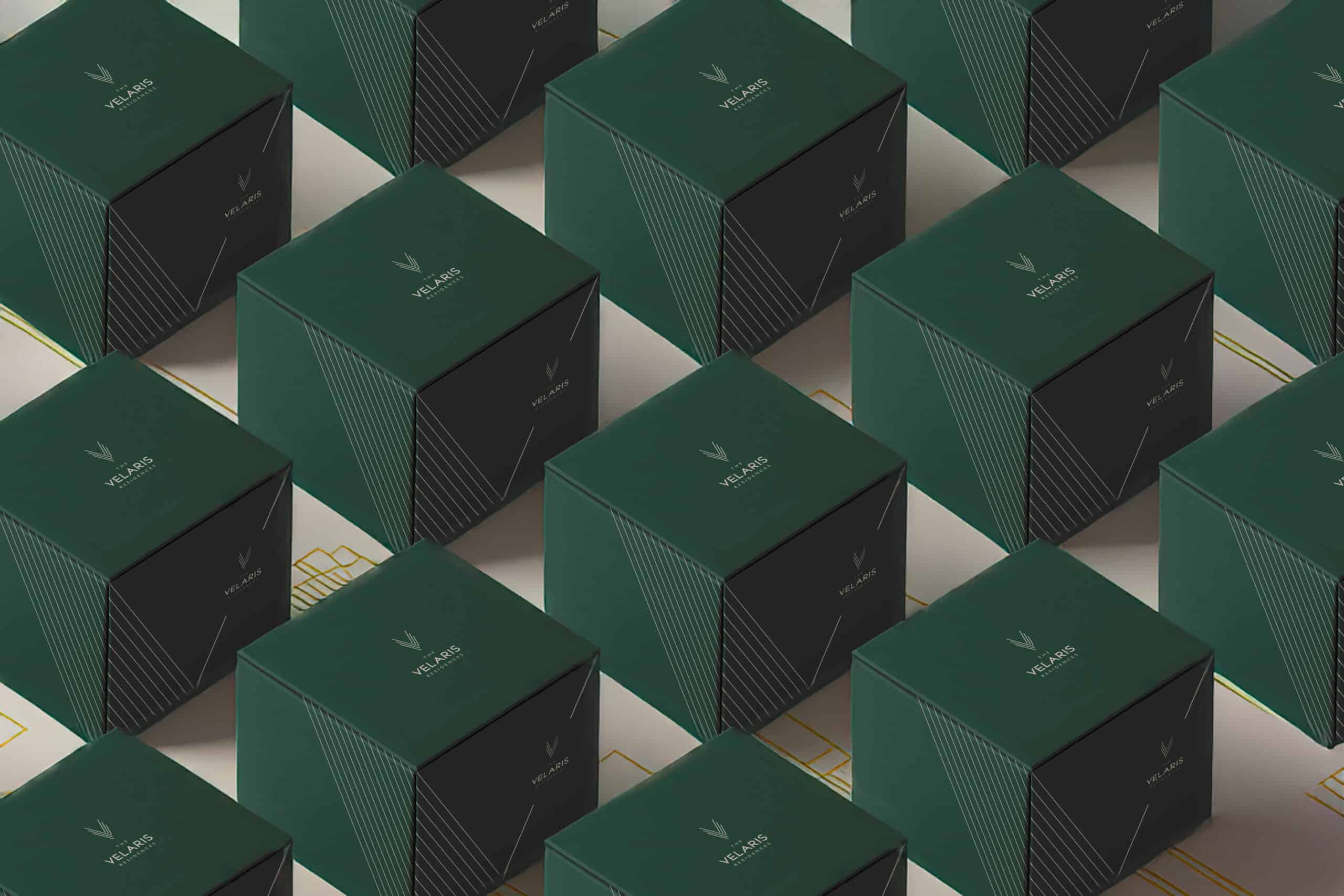 Green Velaris branded boxes with geometric patterns showcasing modern packaging design and visual identity.