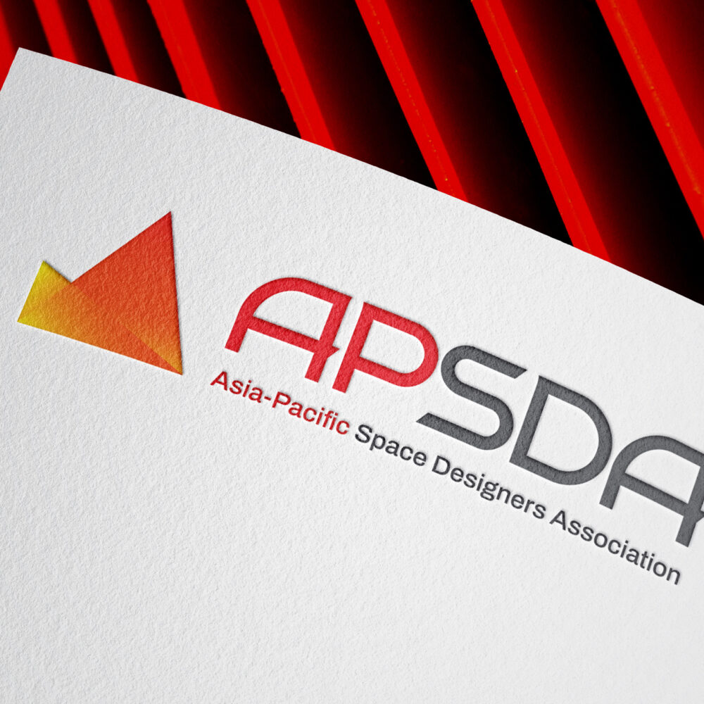 APSDA branding on textured paper with red geometric background, showcasing brand identity and visual design.