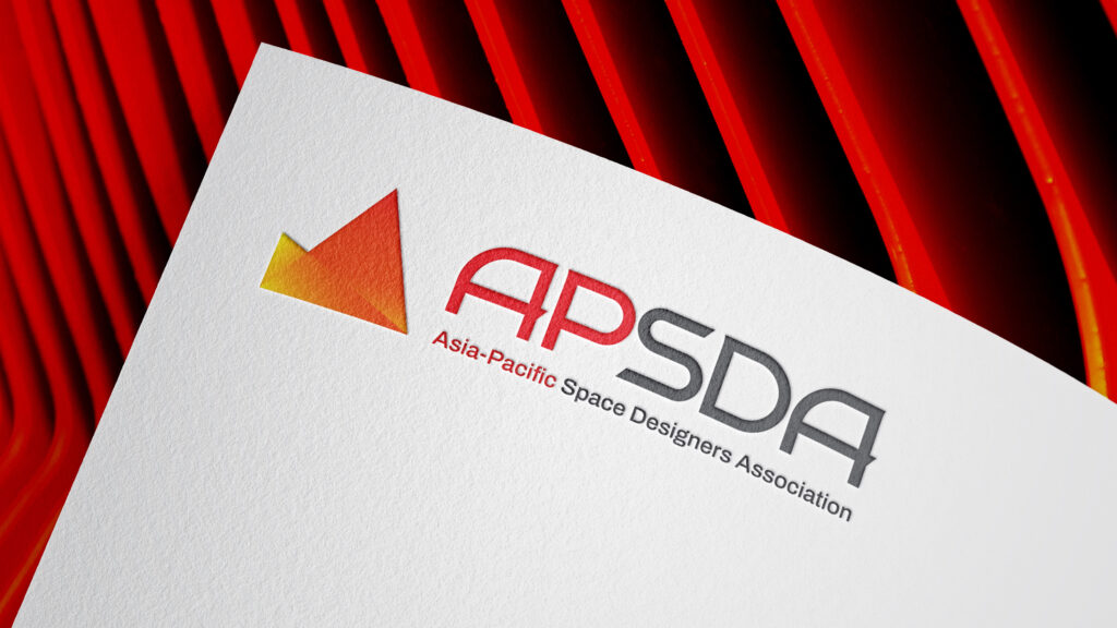 APSDA branding on textured paper with red geometric background, showcasing brand identity and visual design.