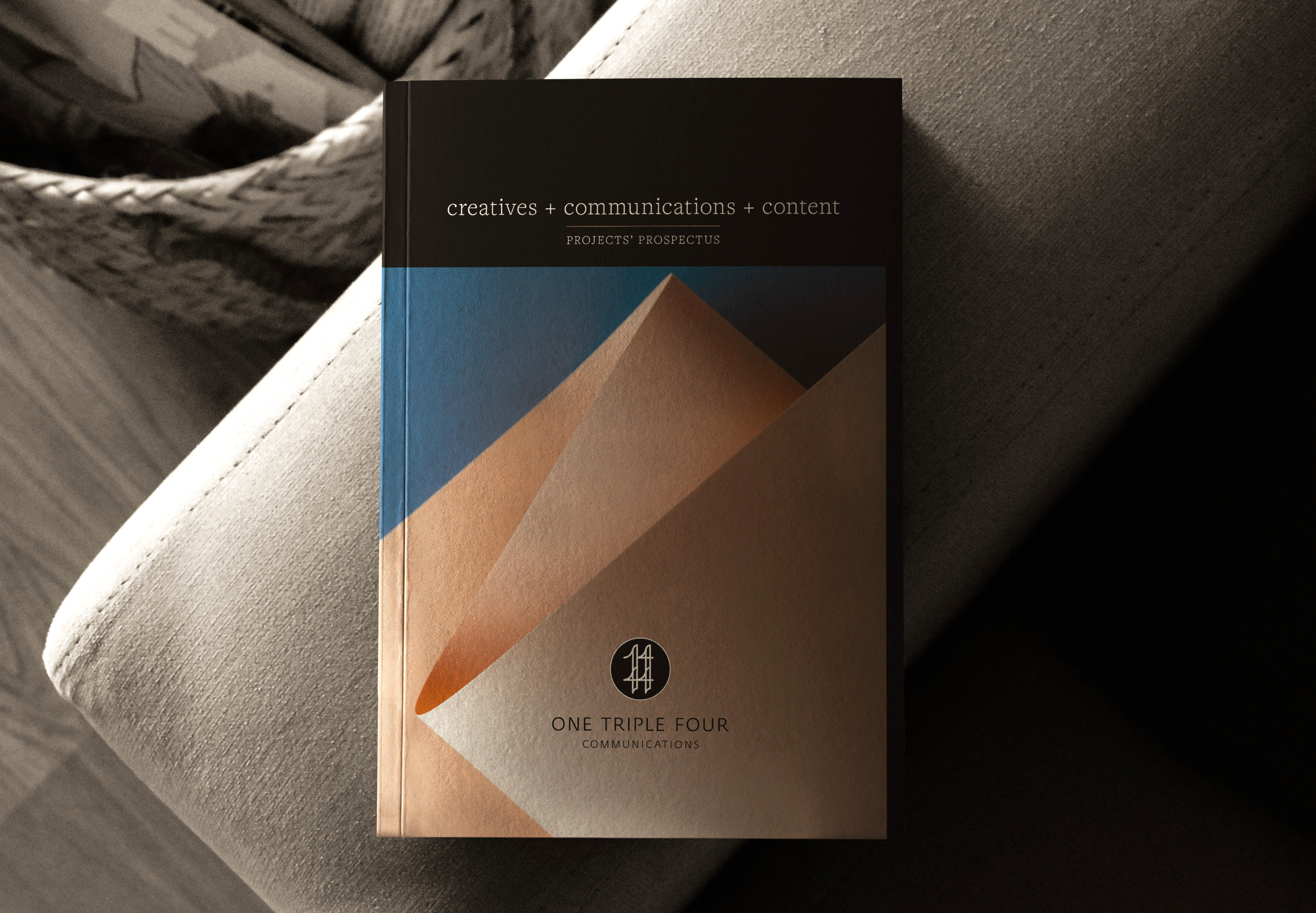 Modern brochure for One Triple Four Communications showcasing creative content, featuring abstract geometric design.