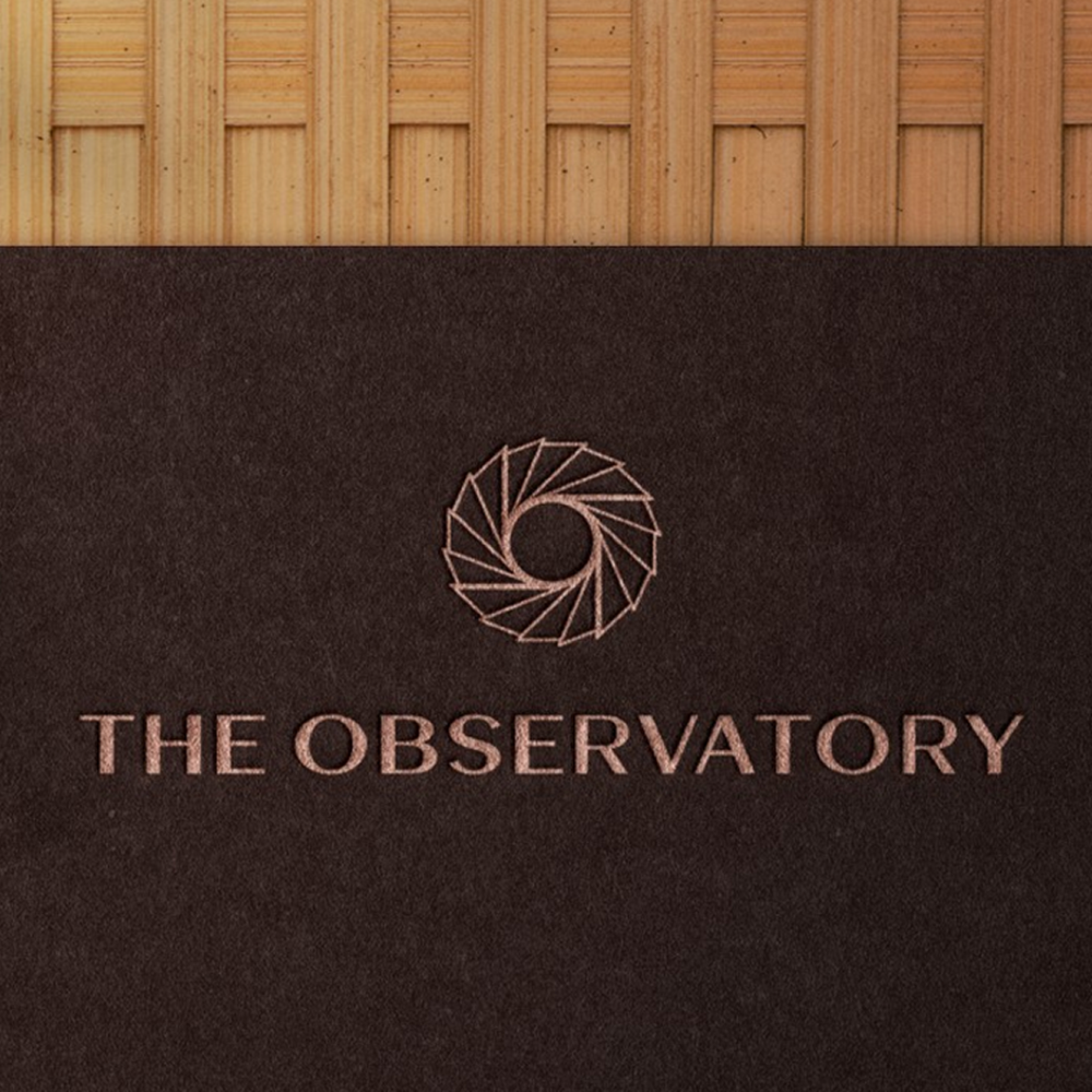 The Observatory branding with logo and name on dark textured background for visual identity project.