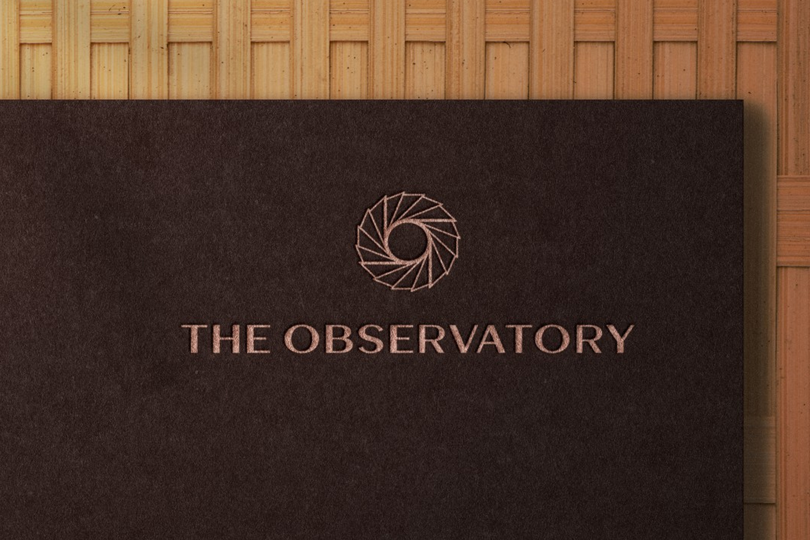 The Observatory branding with logo on dark surface, showcasing visual identity and design elements.