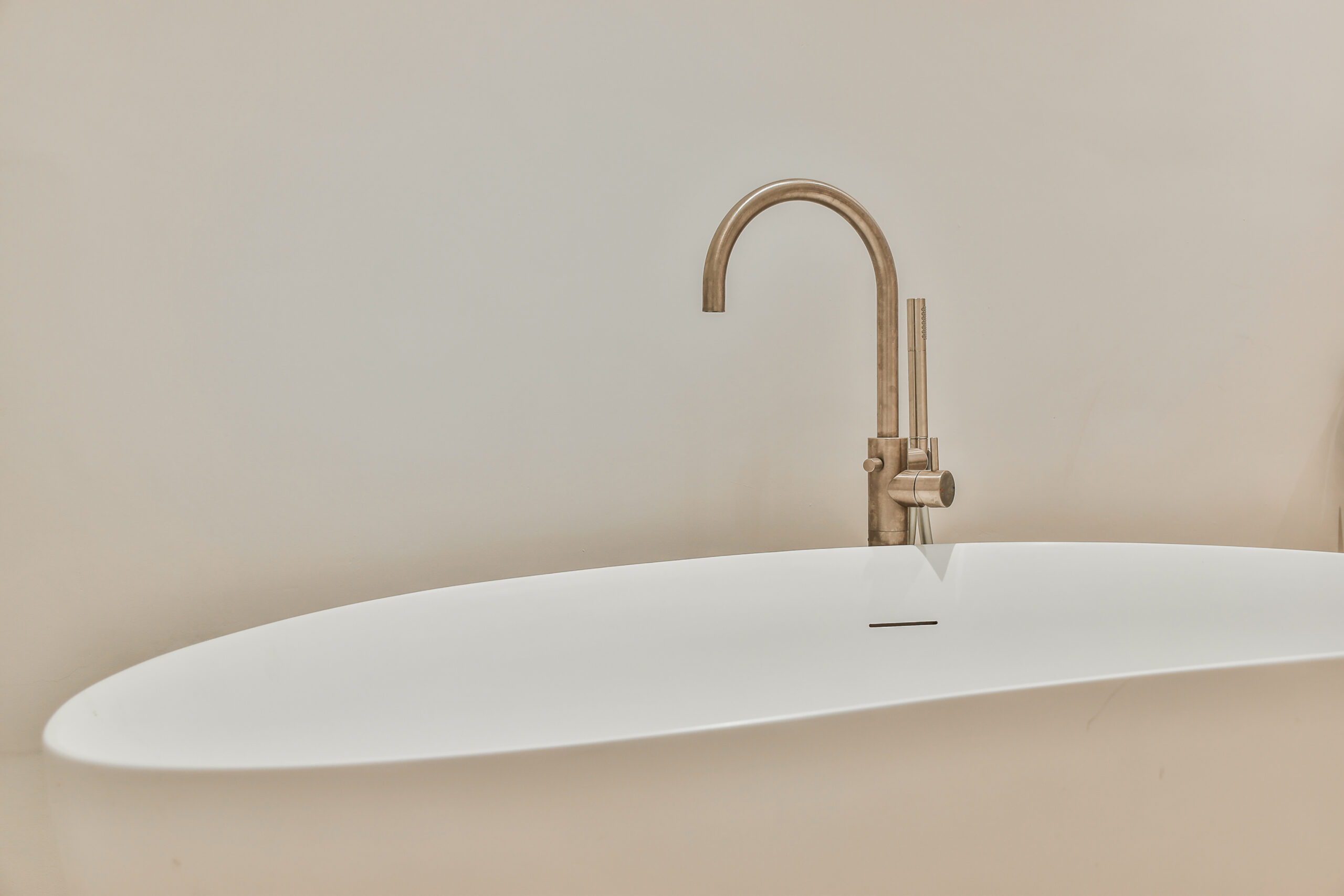 Modern bathroom with a white bathtub and a sleek faucet.
